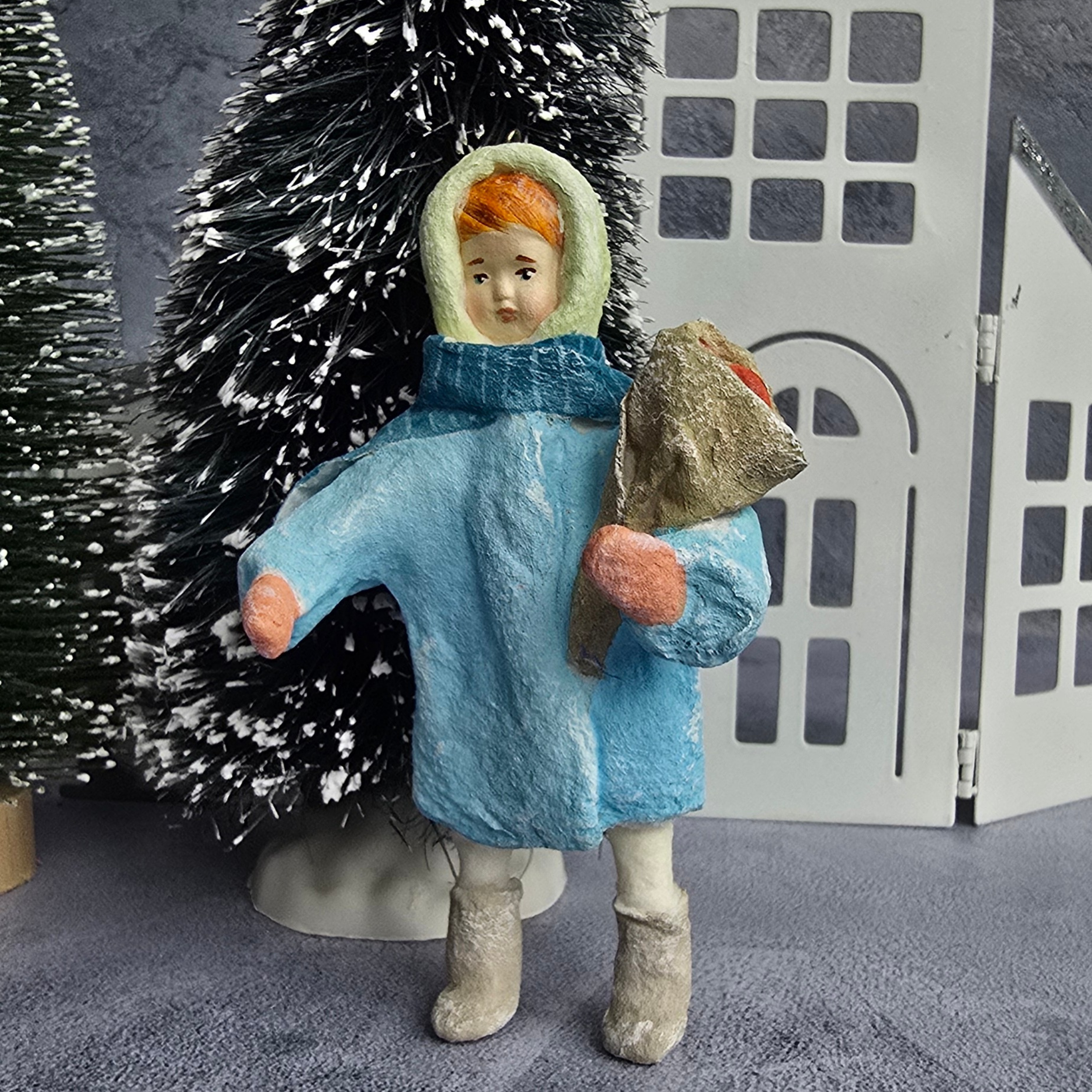 Little girl in vinter clothes with mandarines