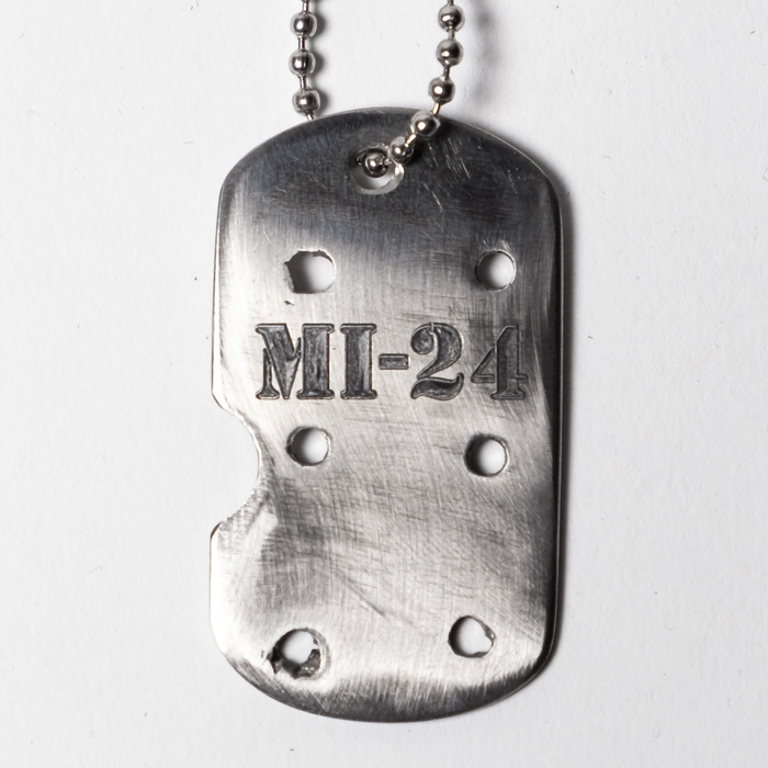 A military dog tag made of a russian shot down MI-24 detail