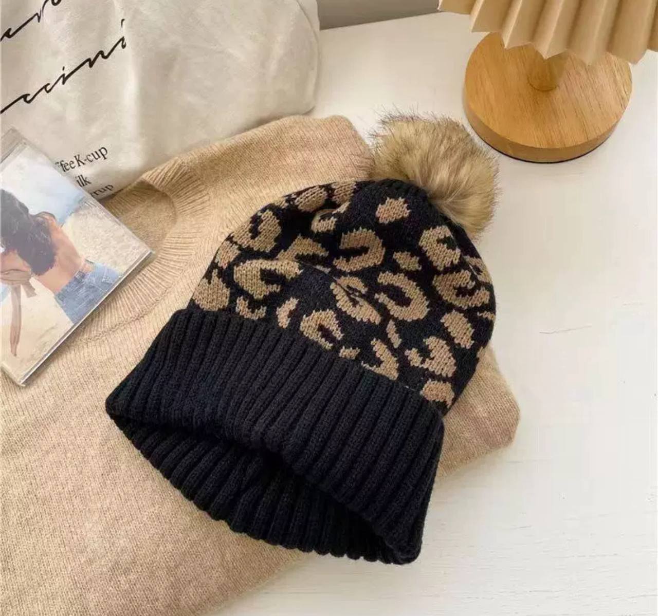Тепла вязана шапка з леопардовим принтом та помпоном